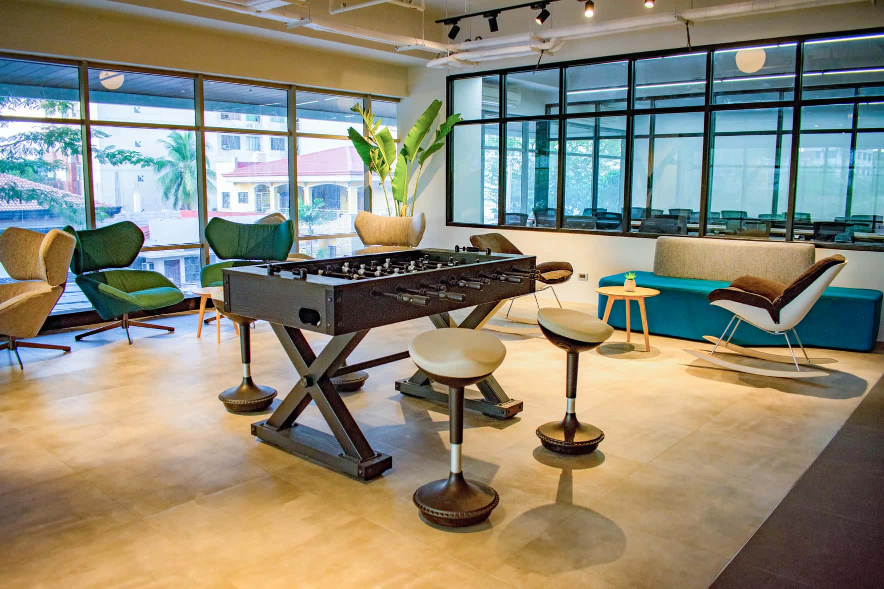 Office lounge and play area with a foosball table and comfortable seating